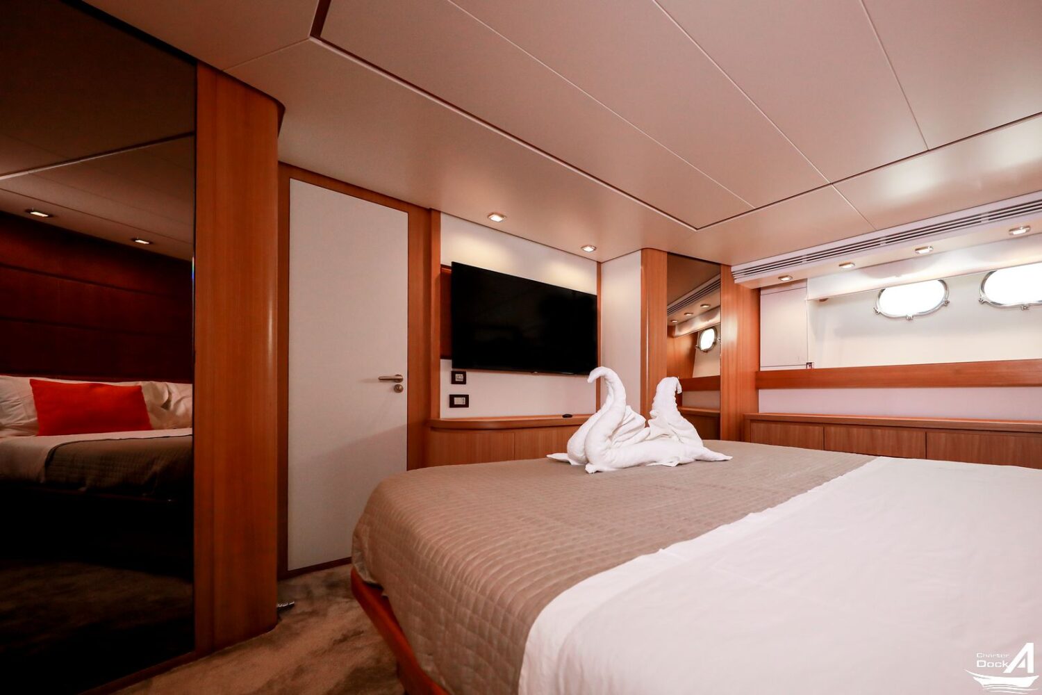 Yacht interior featuring opulent furnishings and large windows overlooking the sea