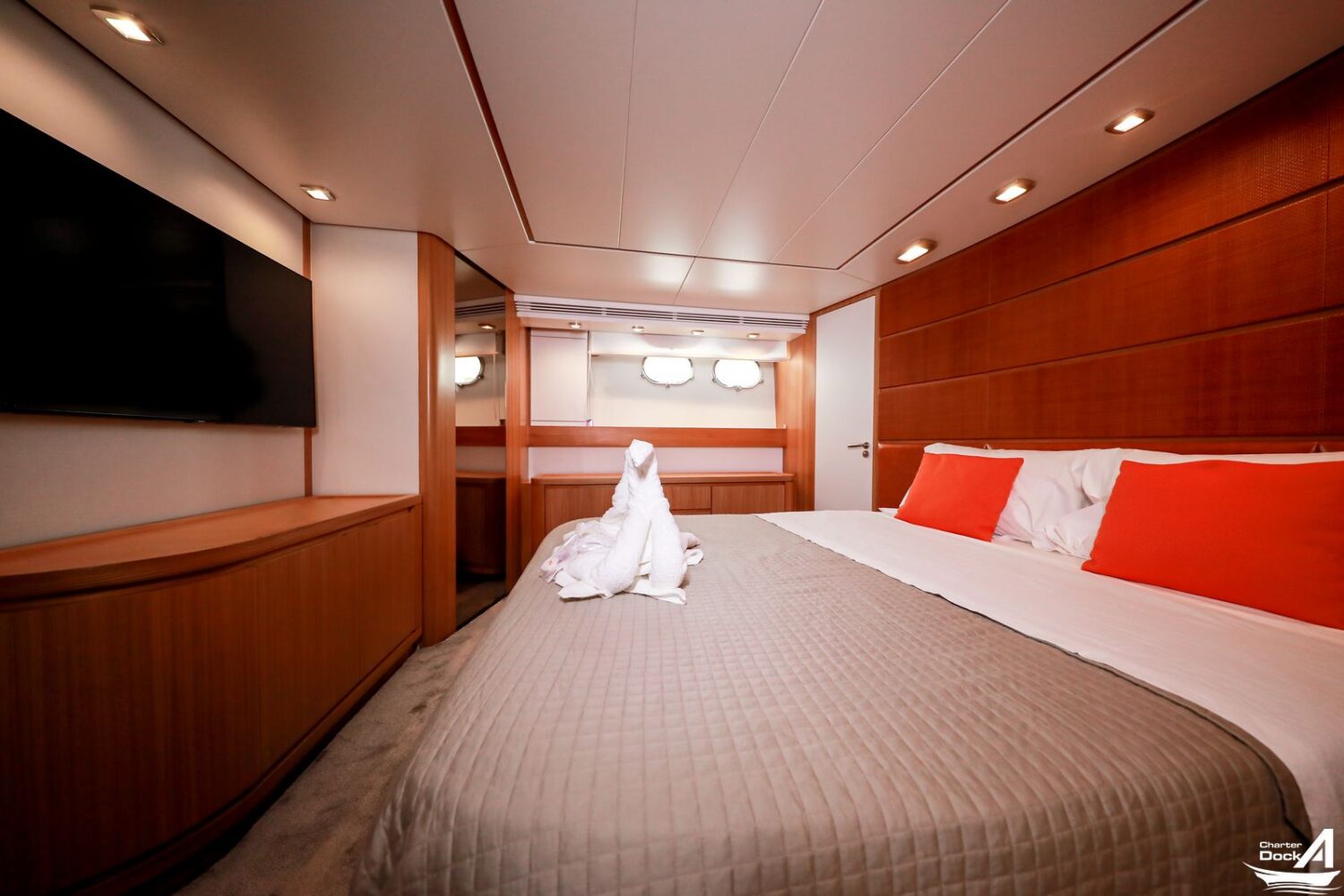 Yacht interior featuring opulent furnishings and large windows overlooking the sea